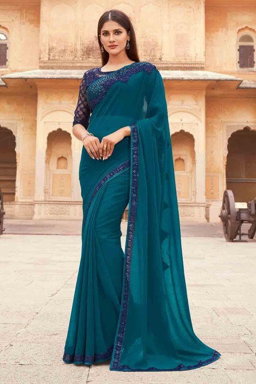 Peacock blue plain body georgette designer saree features contrast magenta  sequin work & embroidered border & blouse
